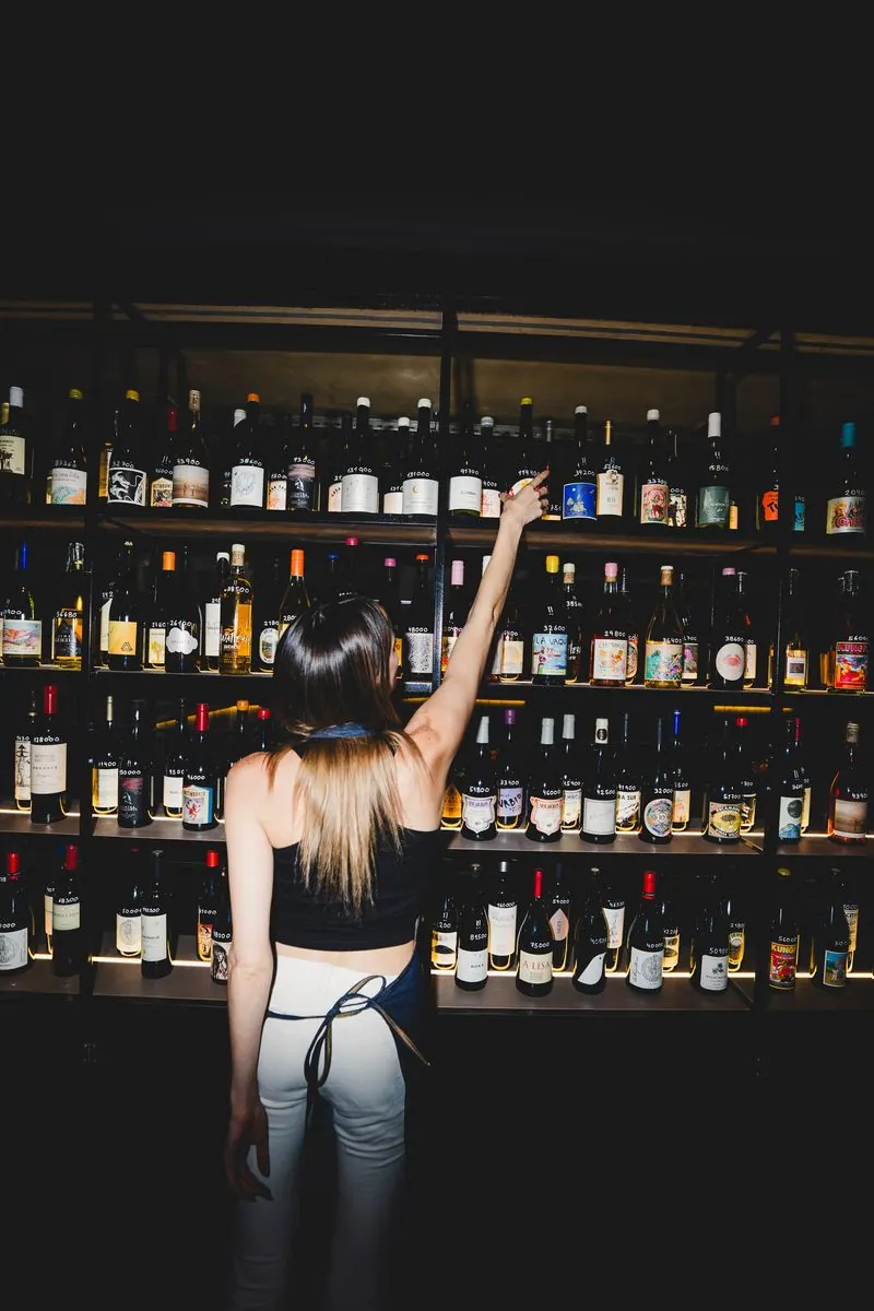 Wall of natural wine bottles at Soler Vino Pizza, Villa Crespo